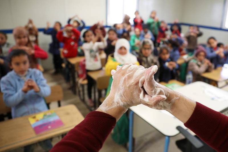 Syrian refugee students take part in a washing hands activity during an awareness campaign about coronavirus initiated by OXFAM and UNICEF at Zaatari refugee camp in Jordan.  Reuters