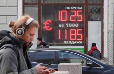 A digital panel displays the euro and US dollar currency rate at an exchange office in St Petersburg, Russia. EPA