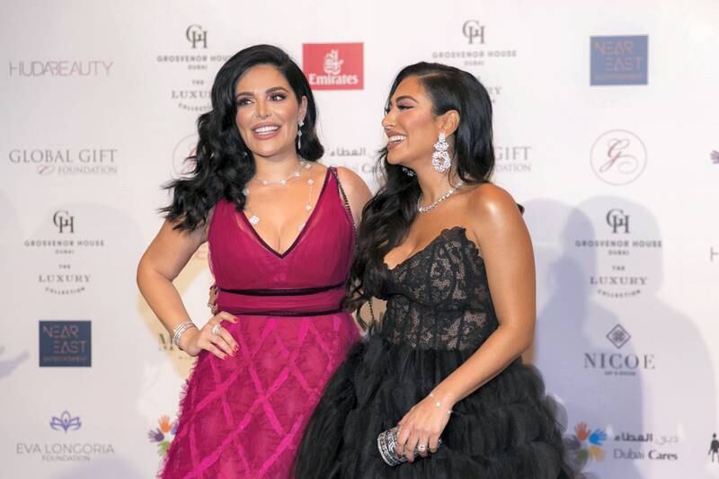 DUBAI, UNITED ARAB EMIRATES - DECEMBER 13, 2018. 

Huda and Mona Kattan at the Global Gift Gala red carpet.

The gala returns to Dubai for the sixth time. The event is held at the Grosvenor House.

(Photo by Reem Mohammed/The National)

Reporter: 
Section:   NA