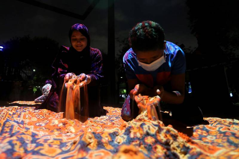 Children play with coloured sand at the inaugural Noor Riyadh festival, in the Saudi Arabian capital. Reuters