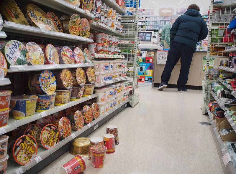 Cup noodles are seen on the floor of a convenience in Sendai on February 13, 2021 after a strong 7.1-magnitude earthquake struck late off the eastern coast of Japan. AFP