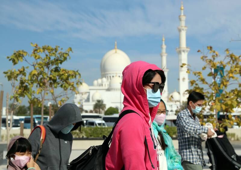 NOTE, NO PERMISSION WAS GIVEN TO TAKE PICS ON SITE AND NO PERMISSION WAS GIVEN BY PEOPLE IN THE PICTURES

Abu Dhabi, United Arab Emirates - Reporter: Picture Desk: Visitors to the Grand mosque in Abu Dhabi wear face masks. Wednesday, January 29th, 2020. The Grand Mosque, Abu Dhabi. Chris Whiteoak / The National