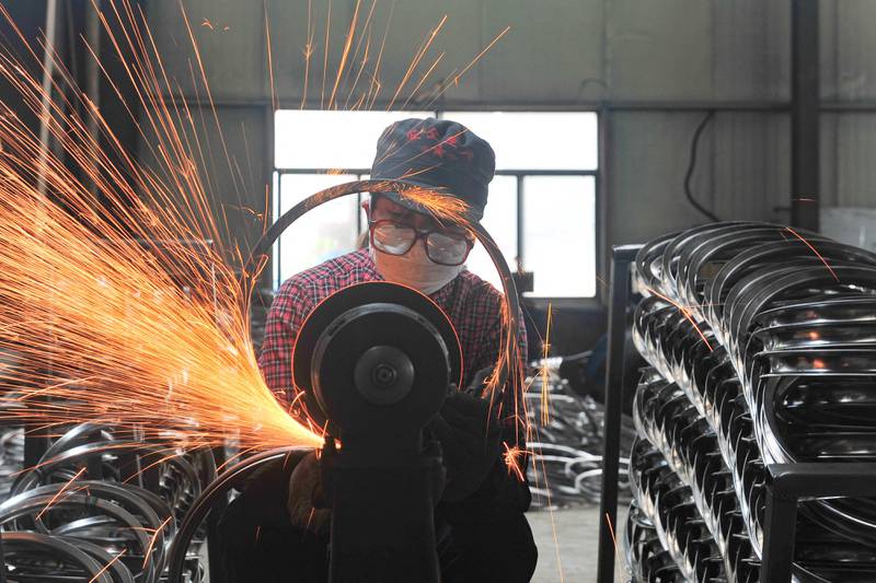 A worker welding wheels at a factory in Hangzhou in China's eastern Zhejiang province.  AFP