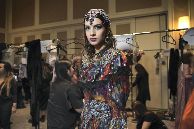 Amid a frenzy of activity, a model prepares to take to the runway. Courtesy Mark Ganzon