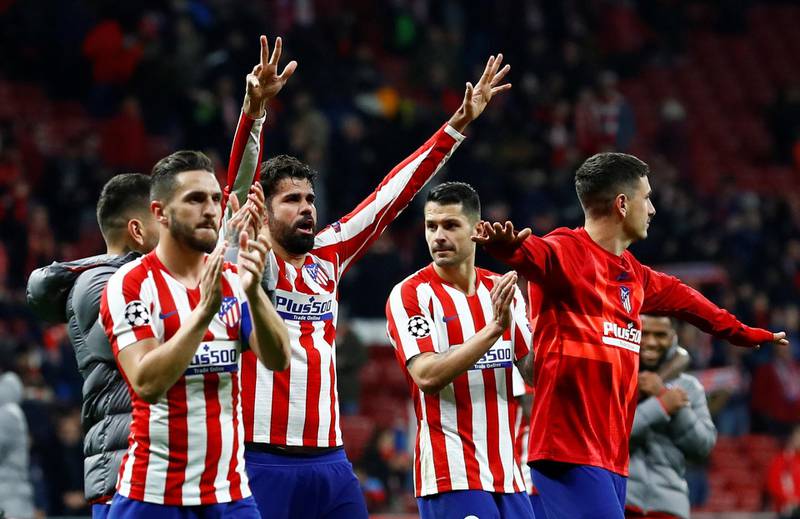 Atletico Madrid's Diego Costa, Mario Hermoso and teammates celebrate after the match. Reuters