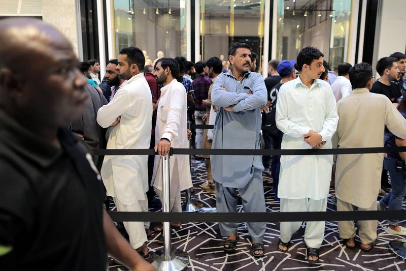Customers queue outside the Apple store at Dubai Mall. Mahmoud Khaled / EPA