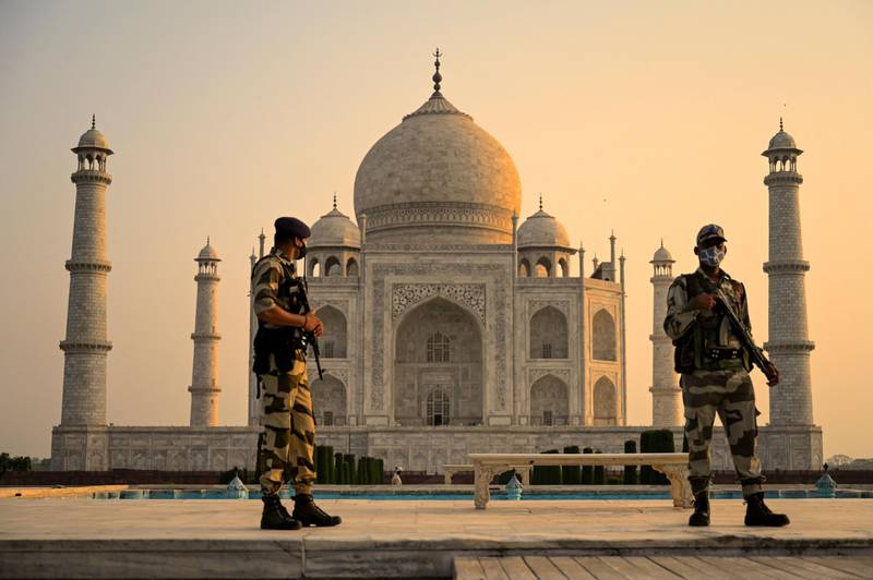 Soldiers patrol the ground at the Taj Mahal after it reopened to visitors following authorities easing Covid-19 coronavirus restrictions in Agra. AFP