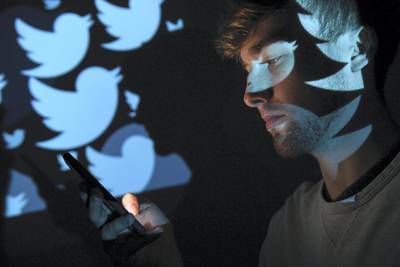 LONDON, ENGLAND - AUGUST 09:  In this photo illustration, the logo for the Twitter social media network is projected onto a man on August 09, 2017 in London, England. With around 328 million users worldwide, Twitter has gone from a small start-up in for the public 2006 to a broadcast tool of politicians and corporations in 2017.  (Photo by Leon Neal/Getty Images)