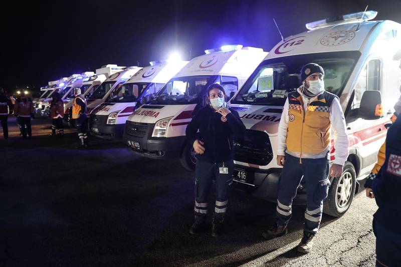 Ambulances and medics wait for the arrival of 42 people from Turkey, Azerbaijan, Georgia and Albania on a Turkish Air Force cargo plane at the Etimesgut military Airport in Ankara after being repatriated from the Chinese city of Wuhan, the epicentre of the new coronavirus outbreak.  AFP