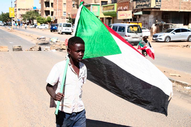 A young Sudanese protester during a demonstration in the capital Khartoum on December 30, 2021, where thousands protested against the army's October 25 coup.  AFP