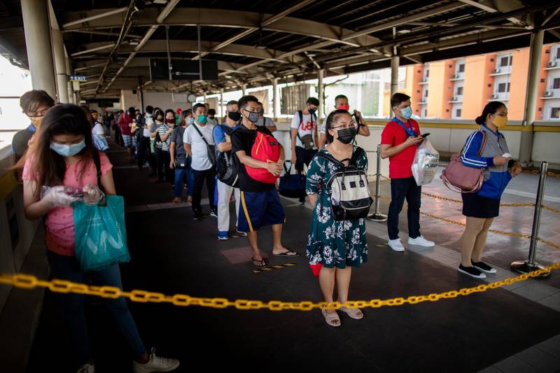 Passengers queue to go to the train platform as social distancing is strictly implemented on the trains on its first day of reopening since the lockdown.  Reuters