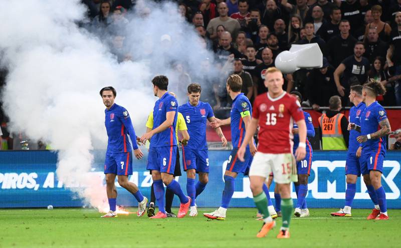 England players look towards the crowd after their game against Hungary in Budapest was interrupted by flares landing on the pitch. England players were also the subject of racist abuse. AFP