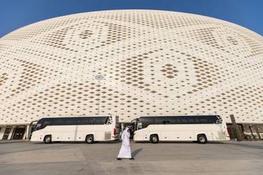 A pedestrian speaks on the phone outside the Al Thumama football stadium in Doha, Qatar, on Monday, June 20, 2022.  The stadium will be a venue for the upcoming 2022 FIFA World Cup in Qatar. Photographer: Christopher Pike / Bloomberg