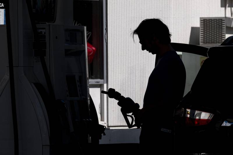 A driver holds a fuel nozzle at a Shell station in San Francisco, California. Bloomberg