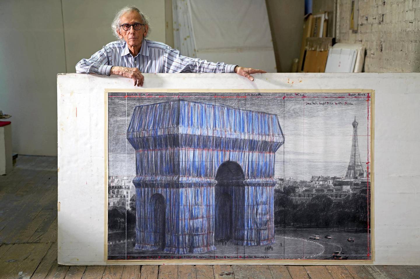 Christo in his studio in 2019 with a preparatory drawing for L'Arc de Triomphe, Wrapped. Courtesy Estate of Christo V Javacheff