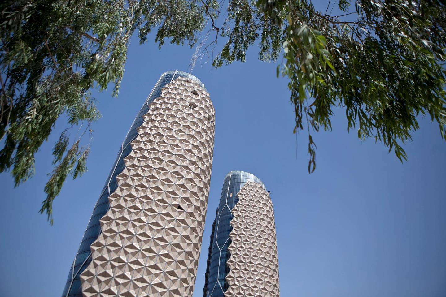 Abu Dhabi, United Arab Emirates, June 12, 2012:   
The Al Bahr Towers in Abu Dhabi use a solar shading system that features a computer-controlled facade made up of thousands of translucent units.  Umbrellas connected to motors open and shut depending on where the sunlight is create an eco friendly building. The towers, on the corner of Saada and Salam Streets in Abu Dhabi will house the offices for the Abu Dhabi Investment Council.  (Silvia Razgova / The National)


     (Note: spelling for the Bahr towers has officially been changed to Bahar - June 12, 2012)