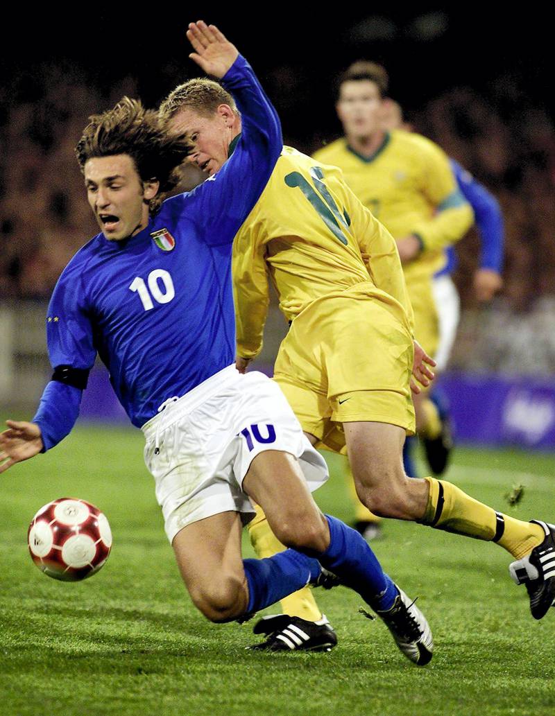 Italian forward Andrea Pirlo (L) is tackled by Australian midfielder Kasey Wehrman (C) during the men's football (SOCCER) preliminary of the Sydney 2000 Olympic Games played in Melbourne, 13 September 2000.  Italy won the second match of the Millennium Games 1 - 0 with a goal by Pirlo.  (ELECTRONIC IMAGE)  AFP PHOTO/Torsten BLACKWOOD (Photo by TORSTEN BLACKWOOD / AFP)
