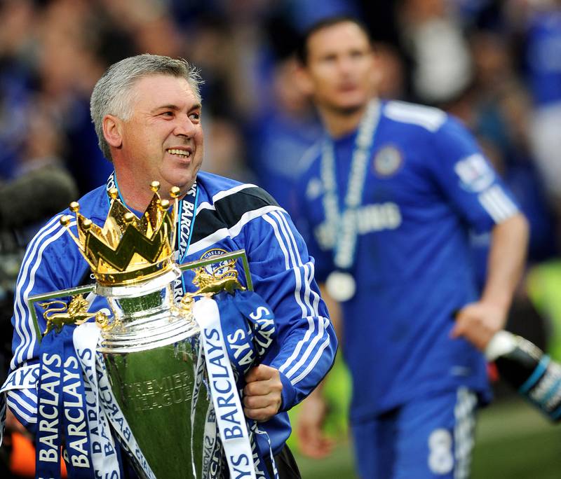 Manager Carlo Ancelotti celebrates with the Premier League trophy after Chelsea won the title with a 8-0 victory over Wigan Athletic at Stamford Bridge on May 9, 2010. AFP