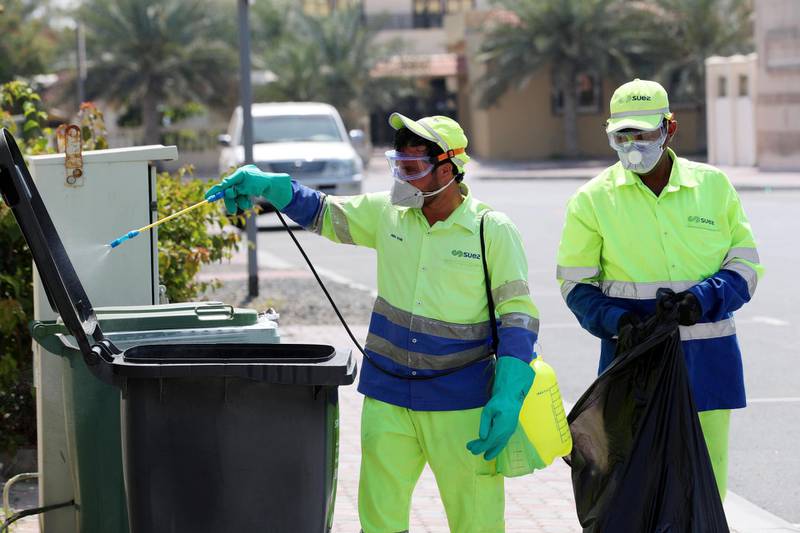 Dubai, United Arab Emirates - Reporter: N/A: People disinfect bins in Jumeirah in response to the corona virus. Wednesday, March 25th, 2020. Dubai. Chris Whiteoak / The National