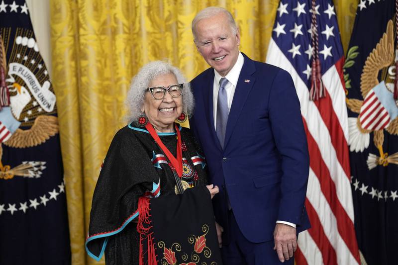 Mr Biden presents the 2021 National Humanities Medal to Native American activist Henrietta Mann. AP