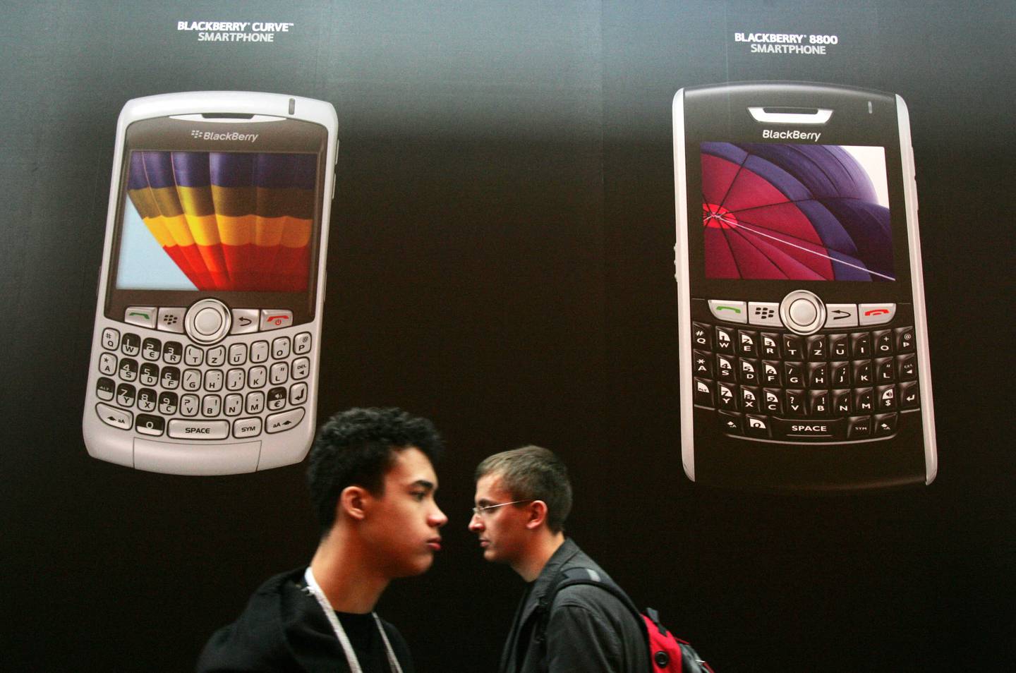 People walk past the BlackBerry stand at a trade fair in Hanover, Germany on March 4, 2008. AFP