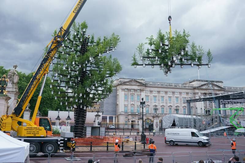 Workers add the final parts to the Tree of Trees sculpture, part of the Queen's Green Canopy Project. The sculpture, which will stand outside Buckingham Palace for the duration of the queen's platinum jubilee celebrations, consists of 350 native British trees planted in aluminium pots. Getty Images