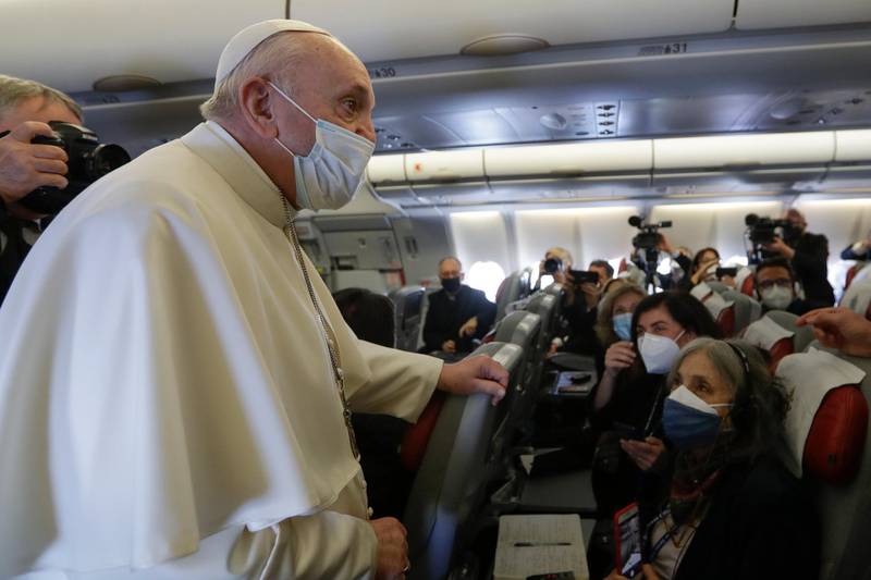 Pope Francis speaks to journalists aboard the airplane heading to Iraq, Friday, March 5, 2021. Pope Francis heads to Iraq on Friday to urge the country's dwindling number of Christians to stay put and help rebuild the country after years of war and persecution, brushing aside the coronavirus pandemic and security concerns. (AP Photo/Andrew Medichini, Pool)
