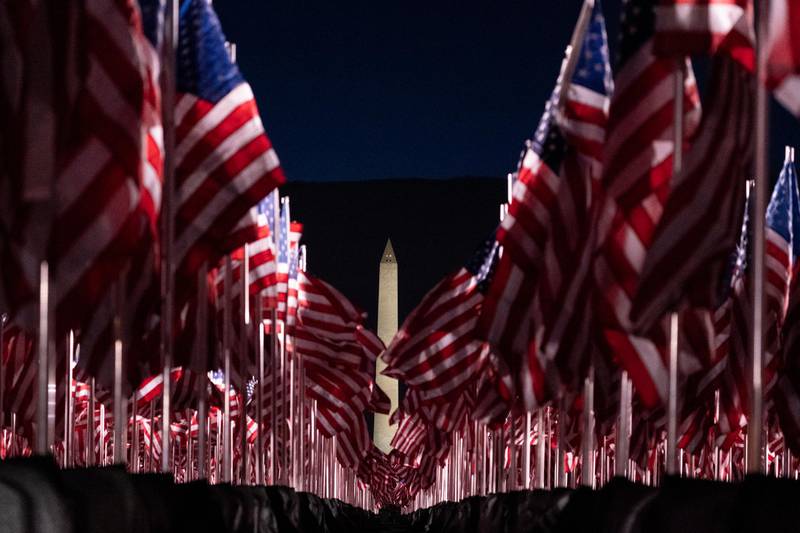 Flags are placed on the National Mall, with the Washington Monument behind them, ahead of the inauguration of President-elect Joe Biden and Vice President-elect Kamala Harris, in Washington. AP Photo