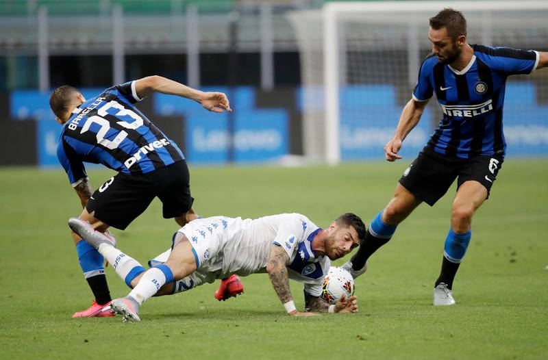 Brescia's Bruno Martella, centre, challenges for the ball with Inter Milan's Nicolo Barella, left, and Roberto Gagliardini. AP Photo