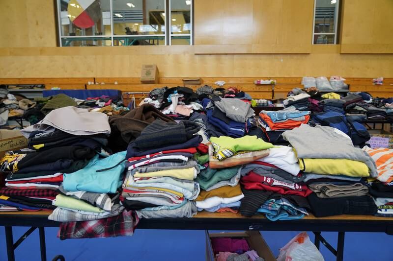 Piles of clothes at the Stein Valley Nlakapamux School in Lytton, BC. The school has served as a place where displaced residents can pick up canned goods and food. Willy Lowry / The National