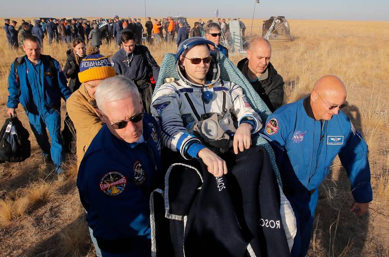 NASA specialists carry US astronaut Nick Hague. AP Photo
