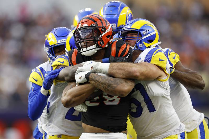 Cincinnati Bengals running back Joe Mixon, centre, is tackled by Los Angeles Rams players at the Super Bowl in Inglewood, California, on February 13. EPA