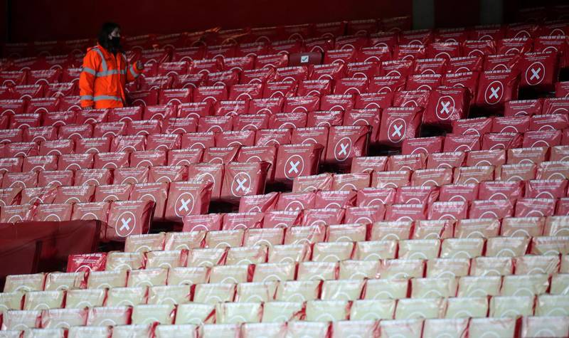 A steward walks among the empty seats in the stadium ahead of the English Premier League football match between Arsenal and Southampton at the Emirates Stadium in London on December 16, 2020.   - RESTRICTED TO EDITORIAL USE. No use with unauthorized audio, video, data, fixture lists, club/league logos or 'live' services. Online in-match use limited to 120 images. An additional 40 images may be used in extra time. No video emulation. Social media in-match use limited to 120 images. An additional 40 images may be used in extra time. No use in betting publications, games or single club/league/player publications.
 / AFP / POOL / PETER CZIBORRA / RESTRICTED TO EDITORIAL USE. No use with unauthorized audio, video, data, fixture lists, club/league logos or 'live' services. Online in-match use limited to 120 images. An additional 40 images may be used in extra time. No video emulation. Social media in-match use limited to 120 images. An additional 40 images may be used in extra time. No use in betting publications, games or single club/league/player publications.
