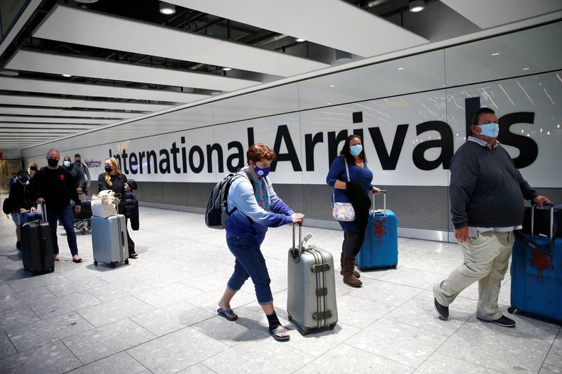 LONDON, ENGLAND - JANUARY 17:Travelers arrive at Heathrow Airport on January 17, 2021 in London, England. Tomorrow morning the UK will close its so-called "travel corridors" with countries from which arriving travelers were exempt from quarantine requirements. People flying into the UK will now be required to quarantine for 10 days unless they test negative for covid-19 after five days, or unless they qualify for a business-travel exemption. (Photo by Hollie Adams/Getty Images)