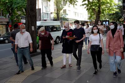 People wear face masks to protect against the spread of coronavirus in Ankara, Turkey. AP Photo