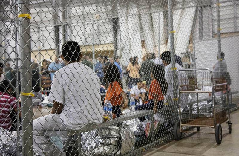 FILE - In this June 17, 2018, file photo provided by U.S. Customs and Border Protection, people who've been taken into custody related to illegal entry cases into the United States sit in one of the cages at a facility in McAllen, Texas. For the opening salvo of his presidency, few expected Joe Biden to be so far-reaching on immigration. A raft of executive orders issued Wednesday, Jan. 20, 2021, undoes many of his predecessor's hallmark initiatives. (U.S. Customs and Border Protection's Rio Grande Valley Sector via AP, File)