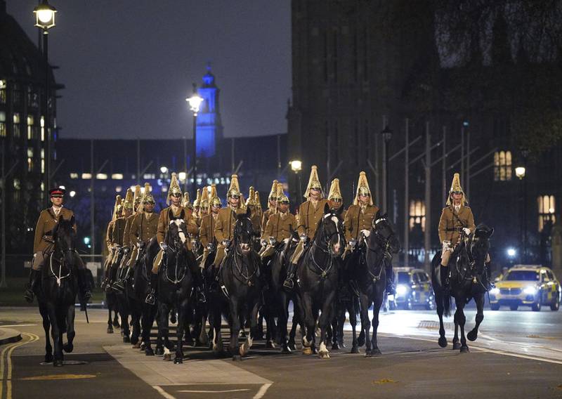 Members of the military pass by Westminster Abbey in central London during a night-time rehearsal for the coronation. AP