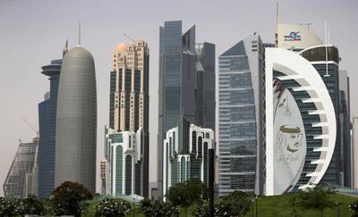 In this May 5, 2018 photo, a giant image of the Emir of Qatar Sheikh Tamim bin Hamad Al Thani, adorns a tower in Doha, Qatar. At a time when the U.S. hopes to exert maximum pressure on Iran, a regional bloc created by Gulf Arab countries to counter Tehran looks increasingly more divided ahead of the anniversary of the diplomatic crisis in Qatar. (AP Photo/Kamran Jebreili)
