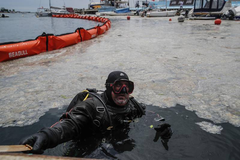 A diver surveys the sea as experts work to clear marine mucilage. AP Photo