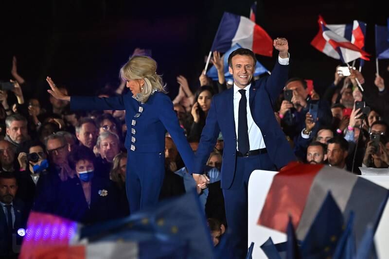 Mr Macron and wife Brigitte celebrate victory over Ms Le Pen in April. Getty