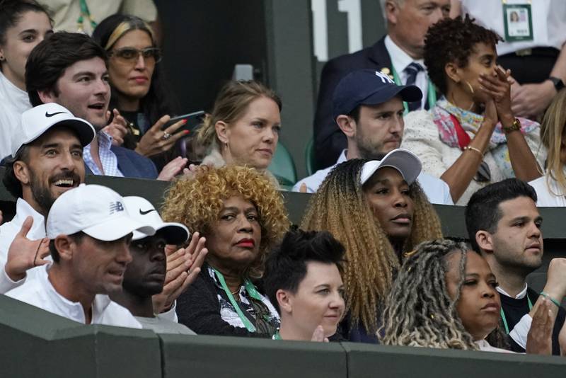 Serena Williams's mother Oracene Price, centre, and sister,  Venus Williams, watch as Serena plays France's Harmony Tan in a first-round women's singles match. AP 