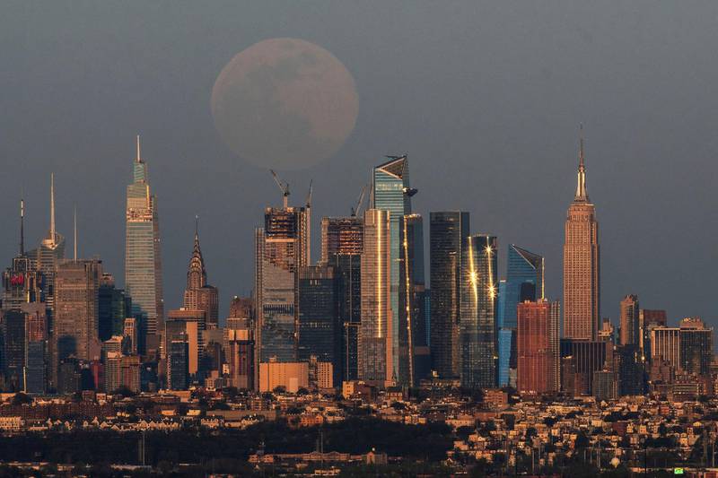 A full pink supermoon rises over the skyline of New York and Empire State Building, as seen from West Orange, in New Jersey, US. Reuters