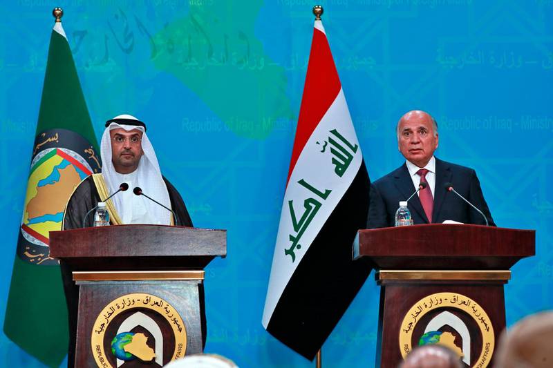Iraqi Foreign Minister Fouad Hussein, right, holds a news conference with visiting Secretary General of the Gulf Cooperation Council, Nayef Falah Al-Hajraf, in Baghdad, Iraq, Monday, Feb, 1, 2021. (AP Photo/Hadi Mizban)