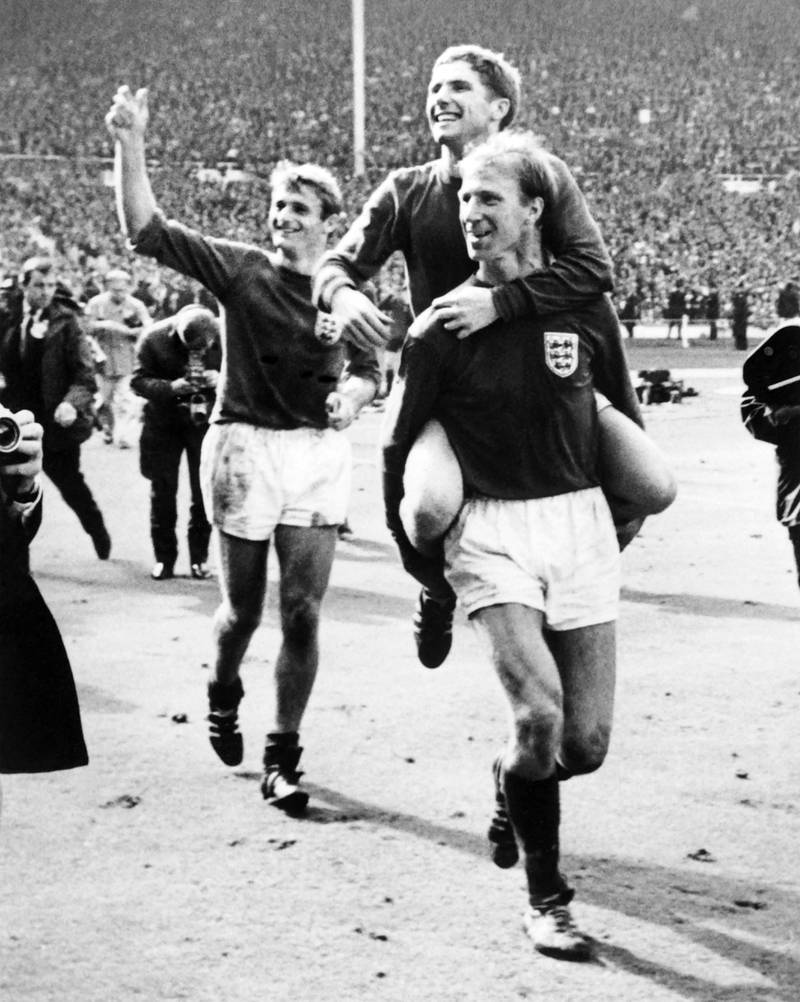 England's Jackie Charlton carries teammate Alan Ball, with Roger Hunt smiling behind, 
after the 1966 World Cup win. AP