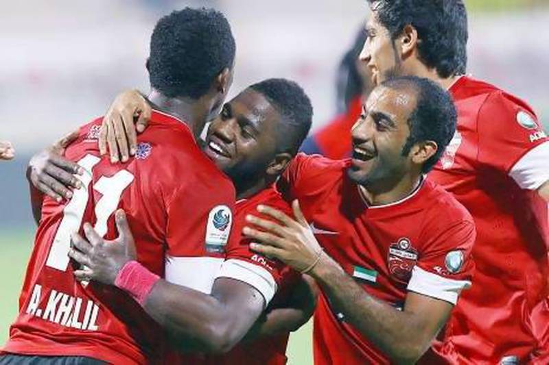 Al Ahli congratulate Ahmed Khalil, left, after he opened the scoring against Al Shaab. Satish Kumar / The National