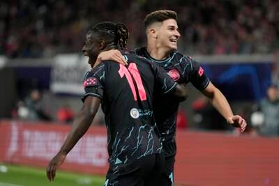 Manchester City's Julian Alvarez celebrates with Jeremy Doku after scoring his side's second goal in the 3-1 Champions League Group G win against RB Leipzig on Wednesday, October 4, 2023. AP