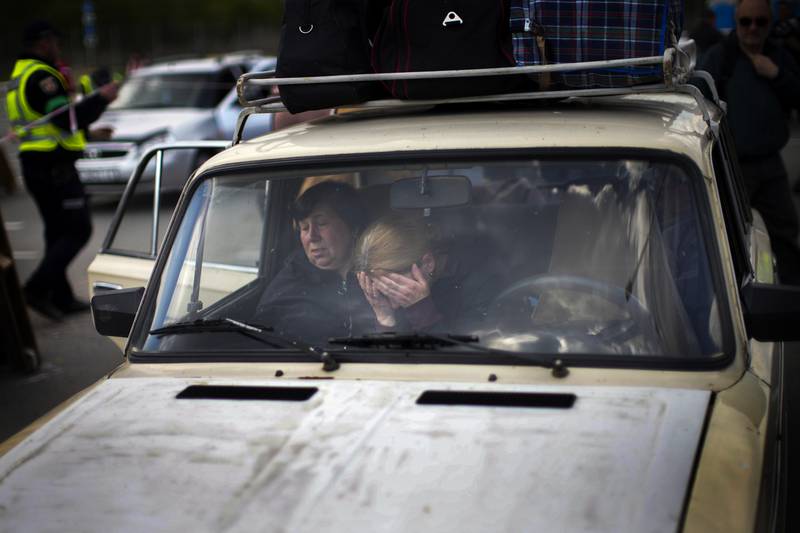 People wait in a car to be processed at a reception centre for displaced people in Zaporizhzhia, Ukraine, on Monday, May 2. AP