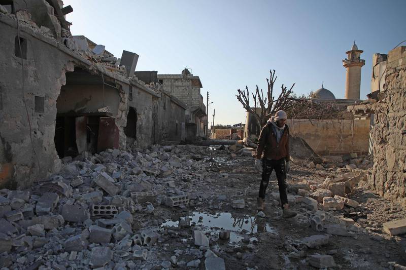 A Syrian man walks amid the rubble of a building following reported air strikes by regime forces on the village of Kityan in Syria's northwestern Idlib province.  AFP