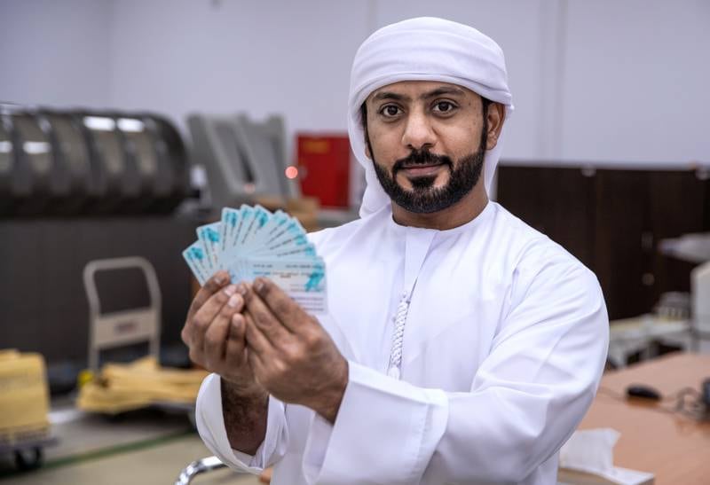 Abu Dhabi, United Arab Emirates, February 10, 2021.  Khaled Al Qubaisi, Quality Control Technician, inspects some newly produced I.D.'s from the printers.Victor Besa/The NationalSection:  NASection:  Nilanjana Gupta