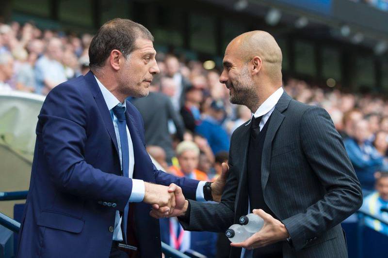 West Ham manager Slaven Bilic, left, and Manchester City manager Pep Guardiola greet each other before the match. Jon Super / AFP